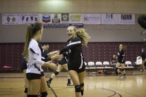 Freshmen Camryn Schultz celebrates with her teammates at the beginning of the game.