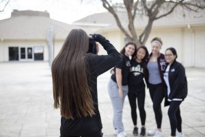 Aubrey Grayham takes picture of yearbook in action.